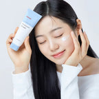 ma:nyo Panthetoin Cream 80ml displayed by a smiling model applying the cream to her face.