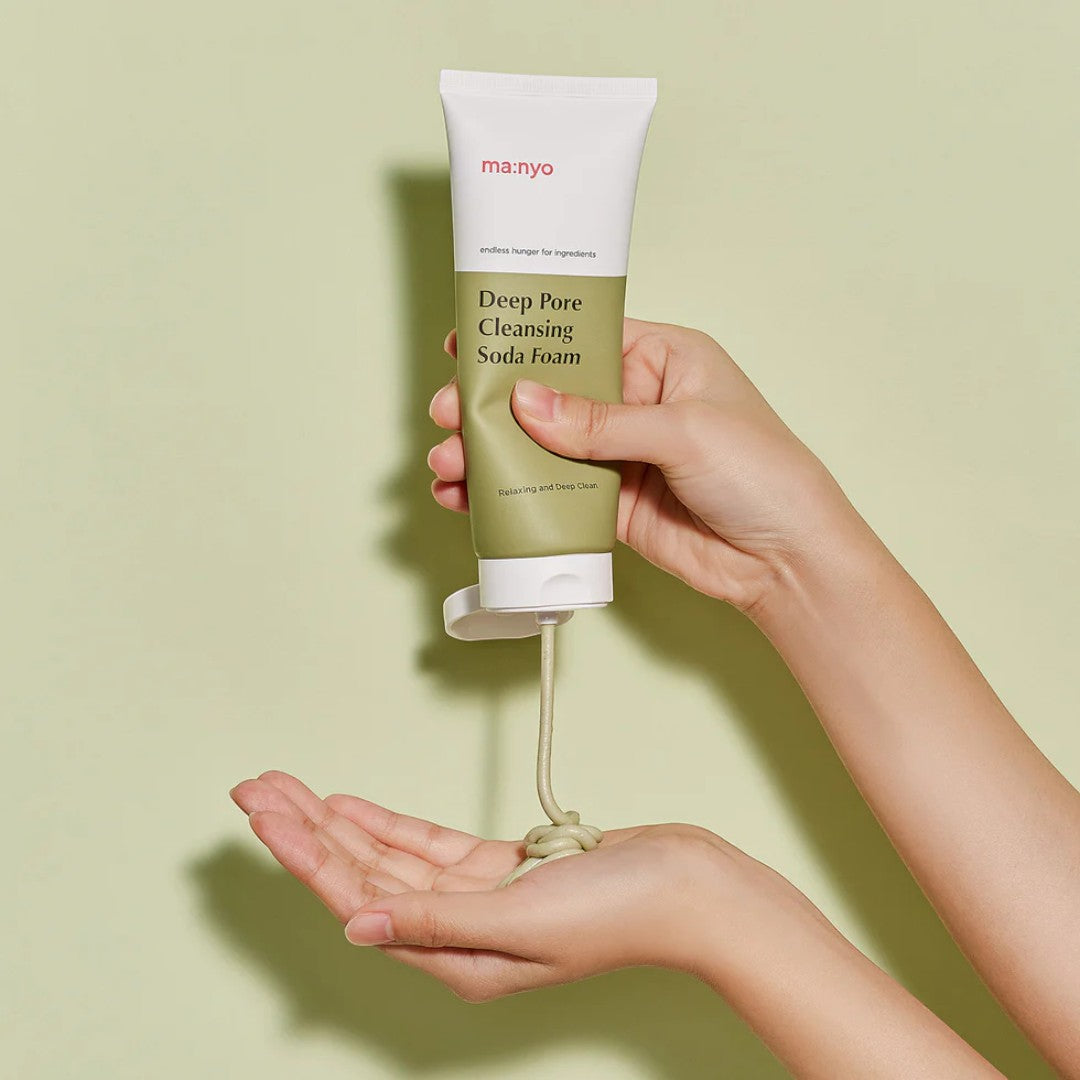 ma:nyo Purifying Cleansing Soda Foam 150ml being dispensed onto a hand, showcasing its texture.