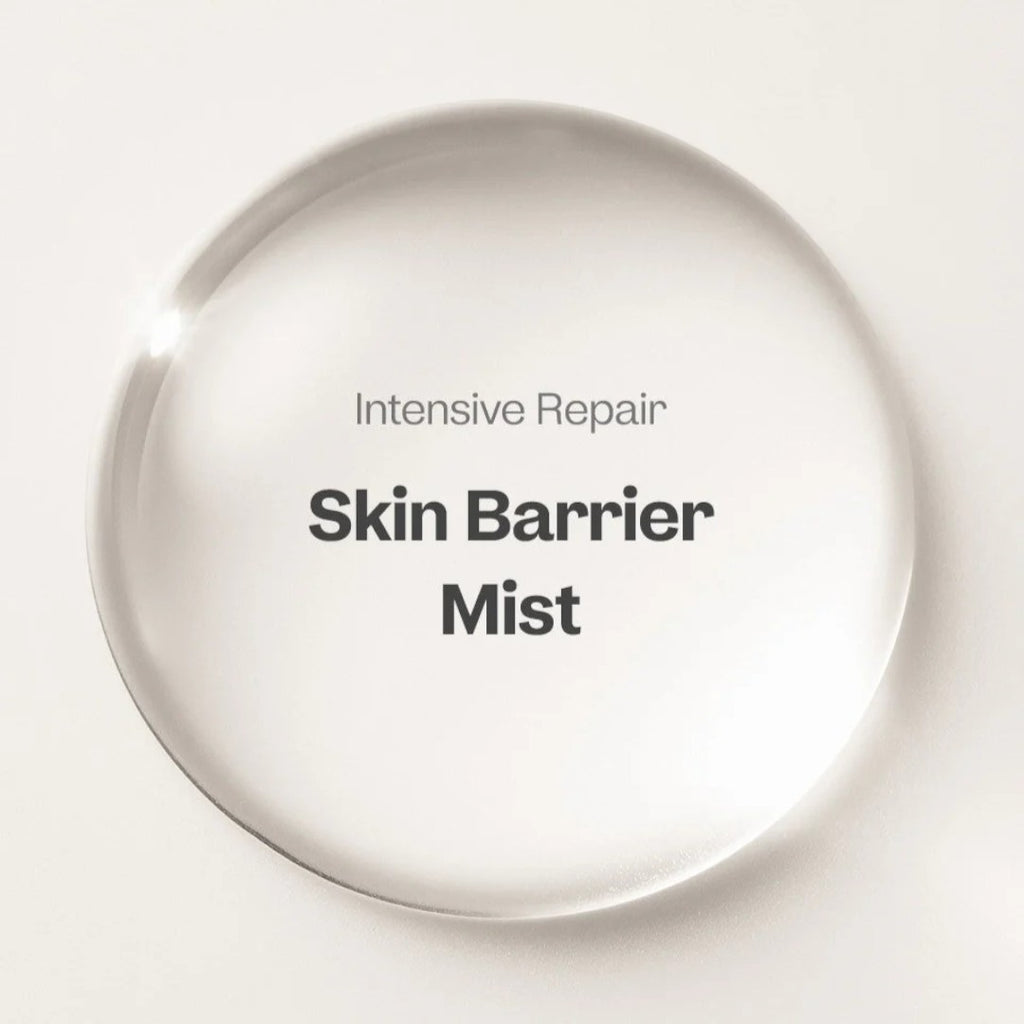 Intensive Repair Skin Barrier Mist in a clear round bottle displayed on a beige background.