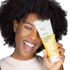 ma:nyo Pure&Deep Cleansing Foam 200ml held by a smiling woman with curly hair, showcasing the product.