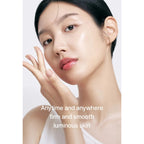 Woman with smooth skin touching her face against a white background