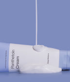 ma:nyo Panthetoin Cream 80ml tube with creamy texture on a blue background.