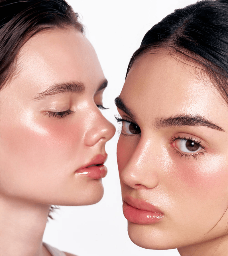 Close-up of two women's faces with a neutral background